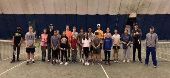 Junior Development tennis players on an indoor court